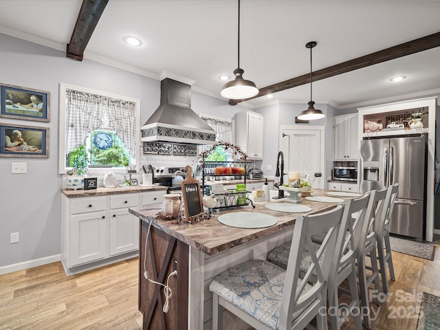 142 Hickory Rd, Lexington, NC 27292 - kitchen with appliances with stainless steel finishes, wall chimney range hood, beam ceiling, backsplash, and light wood-style flooring