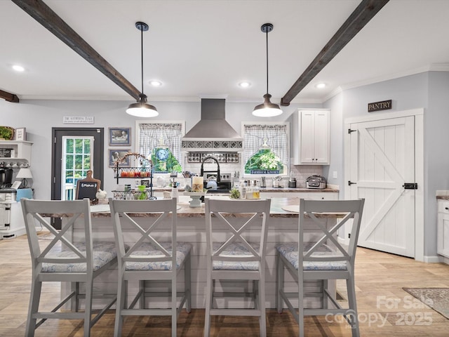 142 Hickory Rd, Lexington, NC 27292 - kitchen featuring wall chimney range hood, beam ceiling, tasteful backsplash, recessed lighting, and a kitchen island with sink