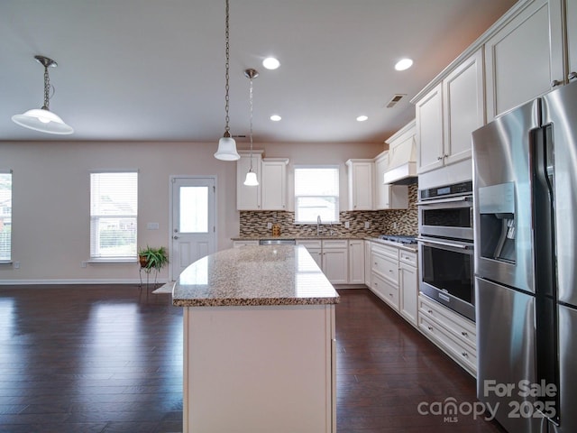 3009 Palm Dr, Fort Mill, SC 29715 - kitchen with appliances with stainless steel finishes, a center island, dark wood-style flooring, decorative backsplash, and recessed lighting