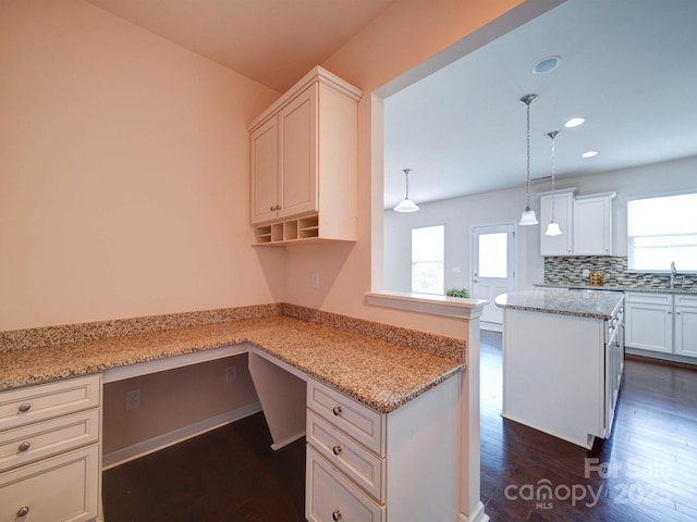 3009 Palm Dr, Fort Mill, SC 29715 - kitchen featuring built in study area, healthy amount of natural light, dark wood-style floors, recessed lighting, and tasteful backsplash