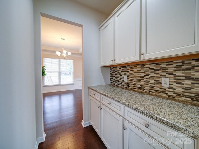 3009 Palm Dr, Fort Mill, SC 29715 - kitchen with tasteful backsplash, a chandelier, white cabinetry, dark wood-style flooring, and light stone counters
