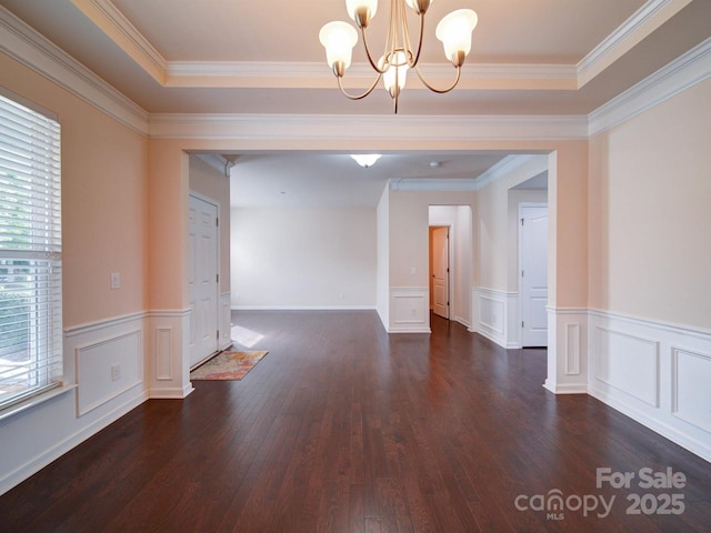 3009 Palm Dr, Fort Mill, SC 29715 - empty room featuring dark wood finished floors, a chandelier, a wainscoted wall, crown molding, and a decorative wall