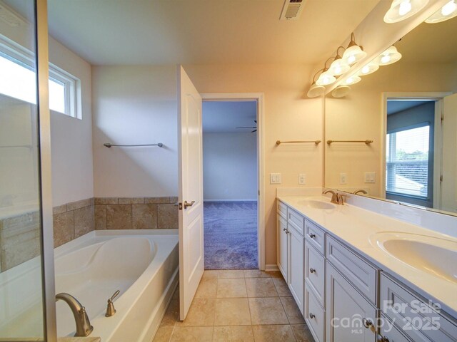 3009 Palm Dr, Fort Mill, SC 29715 - bathroom featuring double vanity, a bath, and tile patterned floors