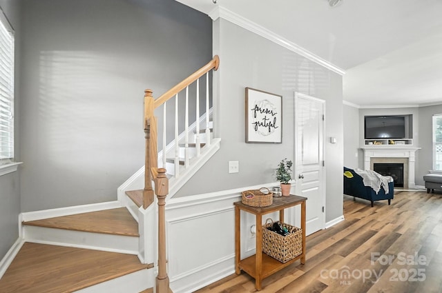 529 River Park Rd, Belmont, NC 28012 - stairway with crown molding, wood finished floors, and a fireplace