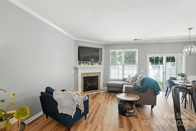 529 River Park Rd, Belmont, NC 28012 - living area featuring ornamental molding, a chandelier, light wood-type flooring, and a fireplace