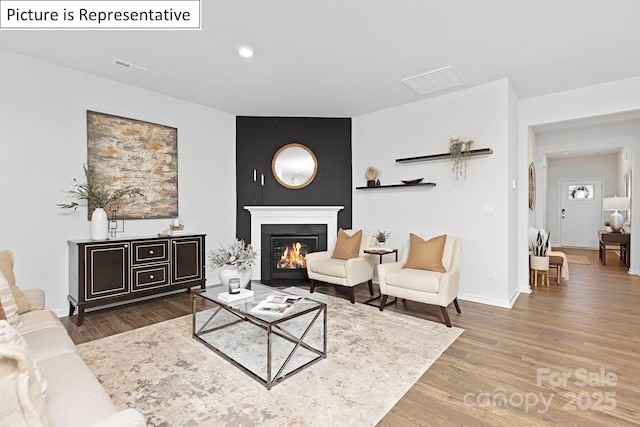 1357 Secrest Commons Dr, Monroe, NC 28112 - living area featuring wood finished floors, a glass covered fireplace, and recessed lighting
