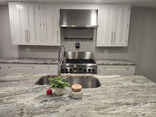 616 Laurel St, Albemarle, NC 28001 - kitchen featuring wall chimney exhaust hood, range, white cabinets, and light stone counters