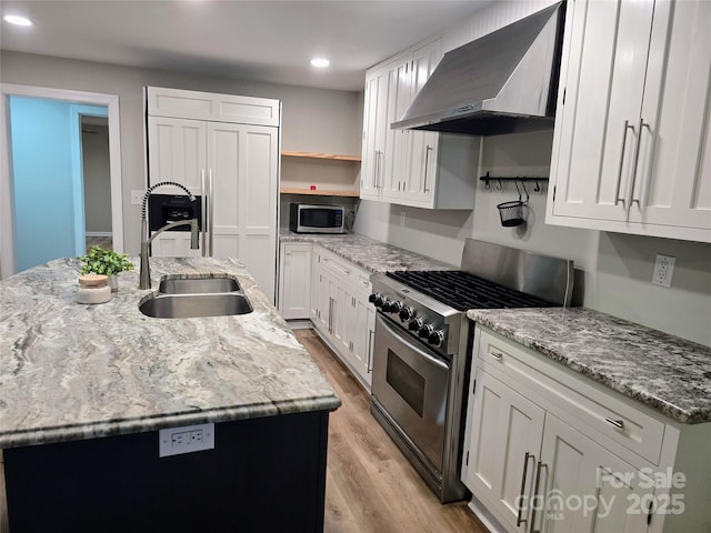 616 Laurel St, Albemarle, NC 28001 - kitchen with wall chimney exhaust hood, appliances with stainless steel finishes, light wood-type flooring, open shelves, and white cabinetry