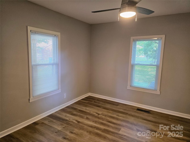 616 Laurel St, Albemarle, NC 28001 - unfurnished room featuring ceiling fan, healthy amount of natural light, and dark wood finished floors