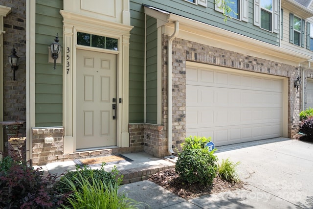 3537 Hornets Nest Way Unit 206, Charlotte, NC 28208 - view of exterior entry with an attached garage and concrete driveway