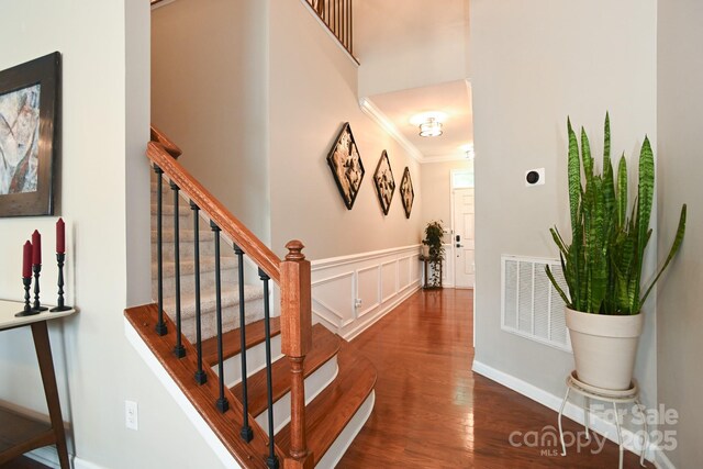 3537 Hornets Nest Way Unit 206, Charlotte, NC 28208 - stairway featuring wood finished floors, ornamental molding, and a wainscoted wall