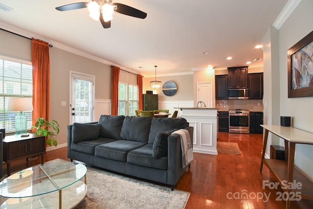 3537 Hornets Nest Way Unit 206, Charlotte, NC 28208 - living room with crown molding, a ceiling fan, dark wood-type flooring, recessed lighting, and wainscoting