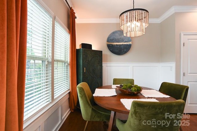 3537 Hornets Nest Way Unit 206, Charlotte, NC 28208 - dining area featuring crown molding, a decorative wall, wood finished floors, wainscoting, and a chandelier