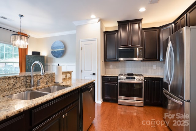 3537 Hornets Nest Way Unit 206, Charlotte, NC 28208 - kitchen featuring stainless steel appliances, ornamental molding, light wood finished floors, light stone counters, and tasteful backsplash