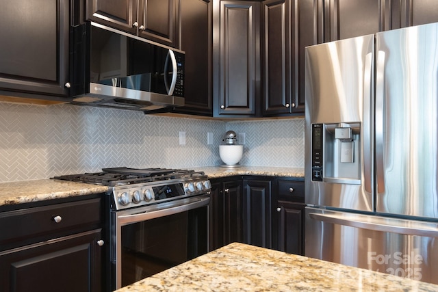 3537 Hornets Nest Way Unit 206, Charlotte, NC 28208 - kitchen with appliances with stainless steel finishes, decorative backsplash, light stone countertops, and dark brown cabinetry