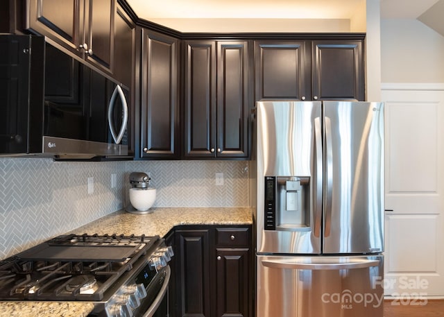 3537 Hornets Nest Way Unit 206, Charlotte, NC 28208 - kitchen with appliances with stainless steel finishes, tasteful backsplash, light stone countertops, and dark brown cabinetry