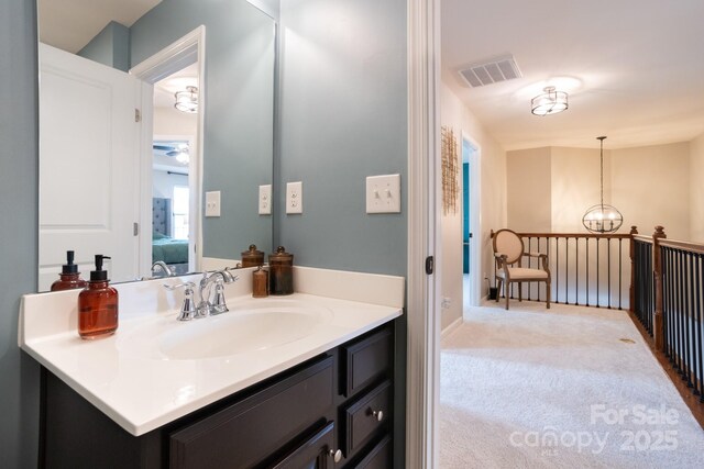 3537 Hornets Nest Way Unit 206, Charlotte, NC 28208 - bathroom with vanity, ensuite bathroom, a chandelier, and ceiling fan