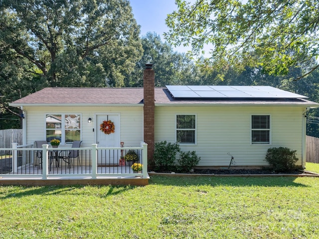 327 Downing St, Troutman, NC 28166 - ranch-style home with roof mounted solar panels and a chimney