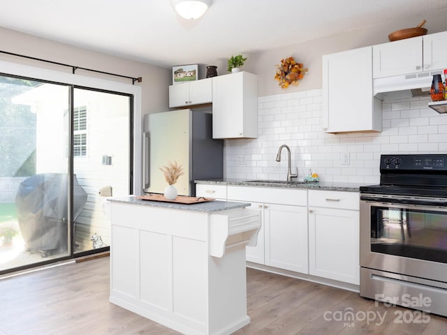 327 Downing St, Troutman, NC 28166 - kitchen featuring appliances with stainless steel finishes, under cabinet range hood, light stone counters, and white cabinetry