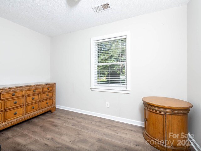 327 Downing St, Troutman, NC 28166 - bedroom featuring wood finished floors and a textured ceiling
