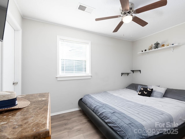 327 Downing St, Troutman, NC 28166 - bedroom with wood finished floors, crown molding, and ceiling fan