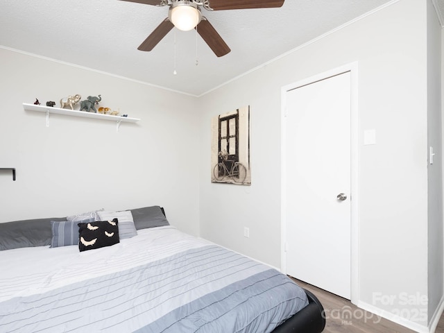 327 Downing St, Troutman, NC 28166 - bedroom with wood finished floors, crown molding, and a ceiling fan