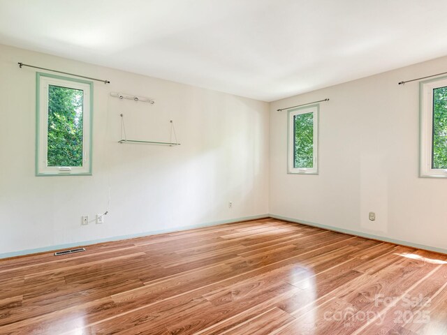 3310 Windbluff Dr, Charlotte, NC 28277 - unfurnished room with plenty of natural light and wood finished floors