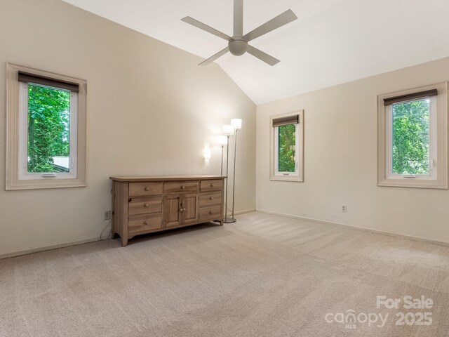 3310 Windbluff Dr, Charlotte, NC 28277 - unfurnished bedroom with light colored carpet, multiple windows, lofted ceiling, and ceiling fan