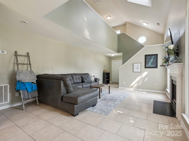 5701 Silver Eagle Dr, Charlotte, NC 28214 - living room with light tile patterned floors, a fireplace, and high vaulted ceiling