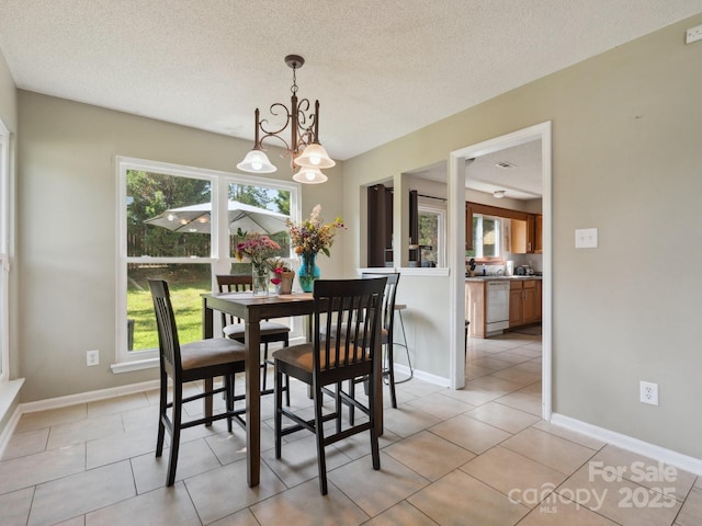 5701 Silver Eagle Dr, Charlotte, NC 28214 - dining space with plenty of natural light, a chandelier, light tile patterned flooring, and a textured ceiling