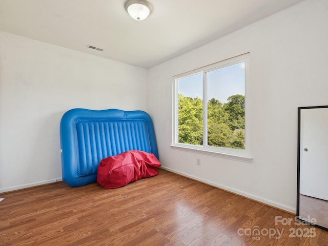 5701 Silver Eagle Dr, Charlotte, NC 28214 - unfurnished bedroom with wood finished floors and baseboards