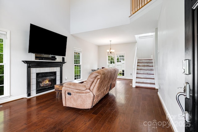 12 Eden Glen Rd, Black Mountain, NC 28711 - living room with a chandelier, dark wood-style floors, a towering ceiling, stairway, and a fireplace