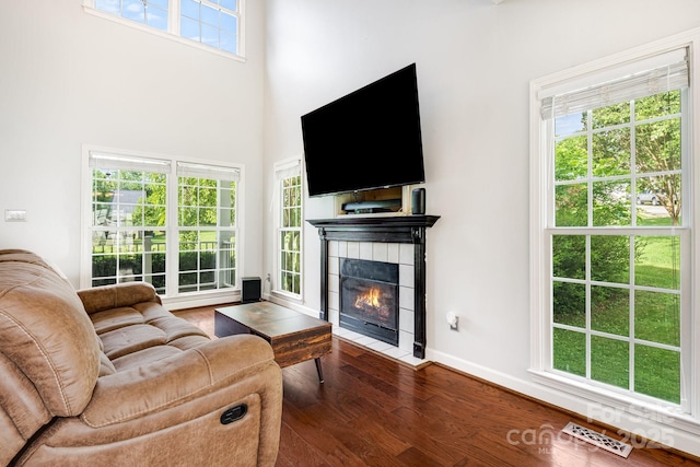12 Eden Glen Rd, Black Mountain, NC 28711 - living room featuring wood finished floors, a fireplace, and a high ceiling