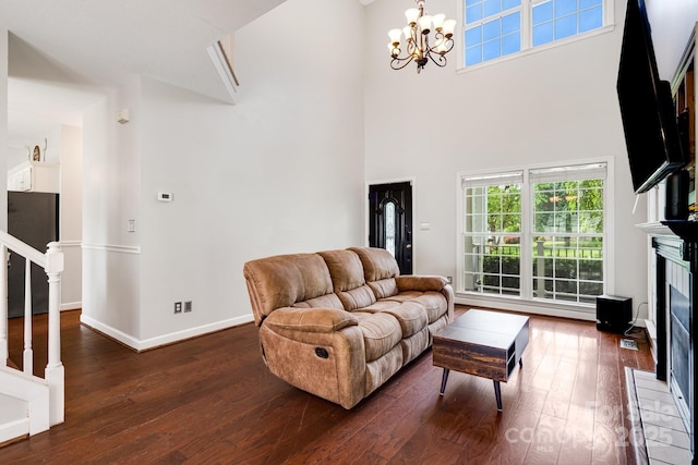 12 Eden Glen Rd, Black Mountain, NC 28711 - living room featuring dark wood finished floors, a fireplace, a towering ceiling, a chandelier, and stairway