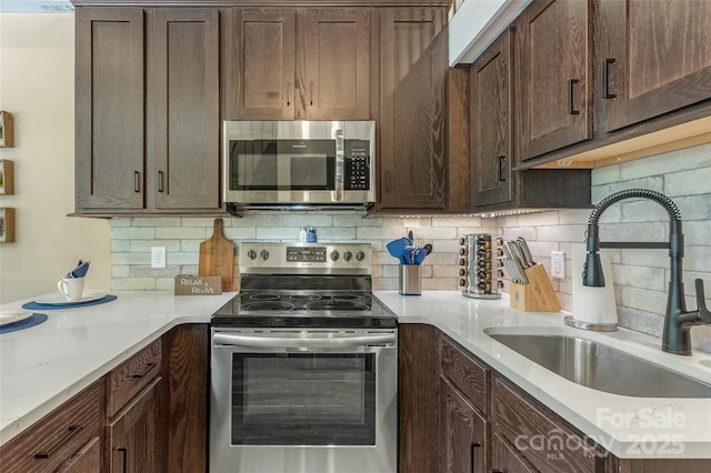 3095 Silversteen Rd, Lake Toxaway, NC 28747 - kitchen featuring appliances with stainless steel finishes, tasteful backsplash, dark brown cabinets, and light stone countertops