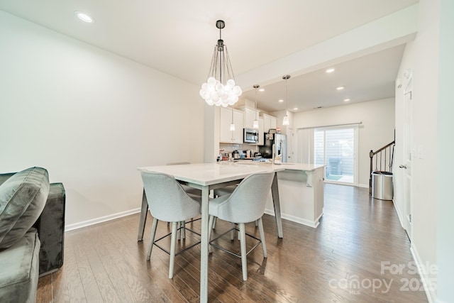 11546 Red Rust Ln, Charlotte, NC 28277 - dining area featuring dark wood-type flooring, recessed lighting, a chandelier, and stairway