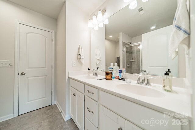 11546 Red Rust Ln, Charlotte, NC 28277 - bathroom featuring double vanity, a shower stall, and tile patterned flooring