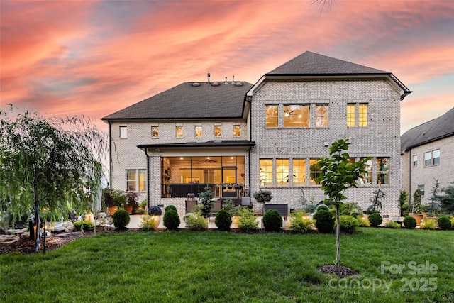 920 Terramore Dr, Waxhaw, NC 28173 - back of house at dusk with brick siding and a lawn