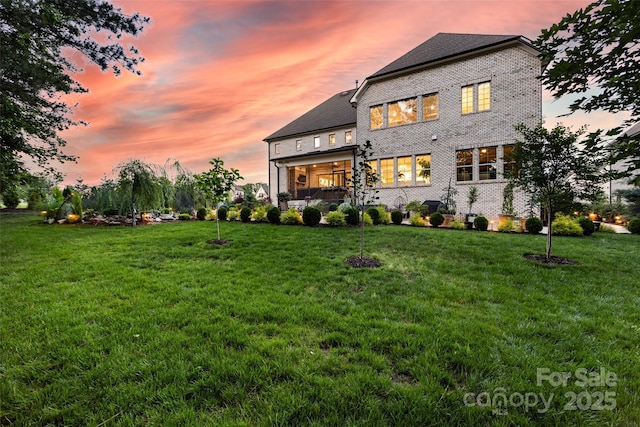 920 Terramore Dr, Waxhaw, NC 28173 - back of house at dusk featuring brick siding and a yard
