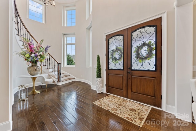 920 Terramore Dr, Waxhaw, NC 28173 - foyer featuring stairway, wood finished floors, a towering ceiling, a chandelier, and french doors
