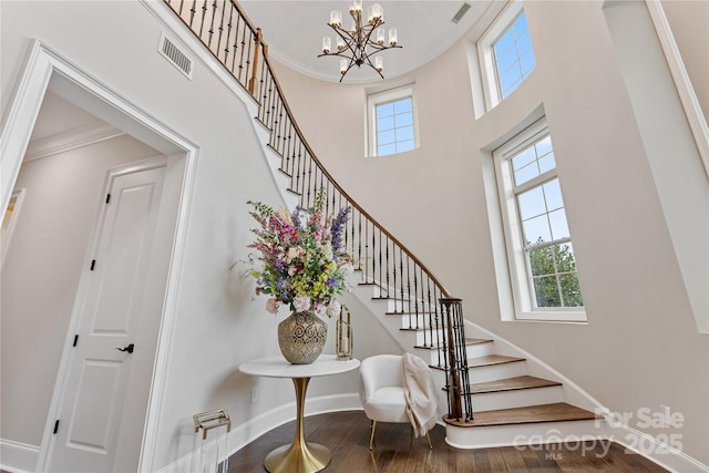 920 Terramore Dr, Waxhaw, NC 28173 - stairs with wood finished floors, ornamental molding, a high ceiling, and a chandelier