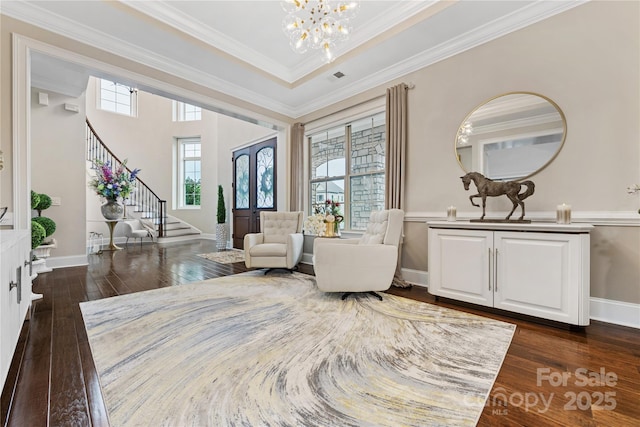 920 Terramore Dr, Waxhaw, NC 28173 - living area with stairway, a chandelier, dark wood-style floors, and ornamental molding