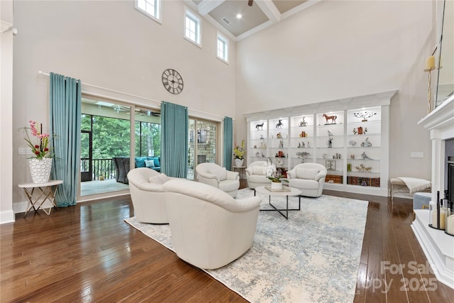 920 Terramore Dr, Waxhaw, NC 28173 - living room with a high ceiling, hardwood / wood-style floors, a fireplace, plenty of natural light, and beamed ceiling