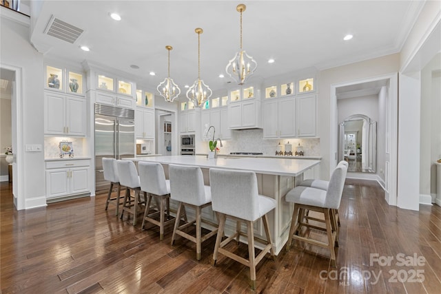 920 Terramore Dr, Waxhaw, NC 28173 - kitchen featuring built in appliances, a chandelier, tasteful backsplash, light countertops, and a spacious island