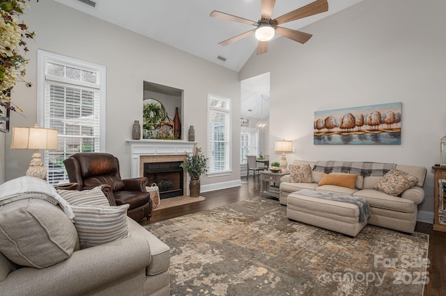 7988 Golf Course Dr N, Denver, NC 28037 - living room featuring wood finished floors, a ceiling fan, a tiled fireplace, and high vaulted ceiling