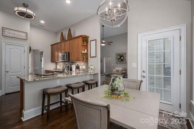 7988 Golf Course Dr N, Denver, NC 28037 - dining area with a chandelier, dark wood-style flooring, recessed lighting, ceiling fan, and high vaulted ceiling