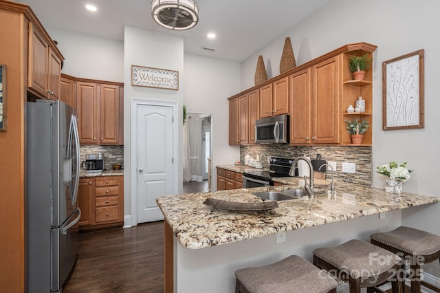 7988 Golf Course Dr N, Denver, NC 28037 - kitchen with appliances with stainless steel finishes, a peninsula, backsplash, light stone countertops, and open shelves