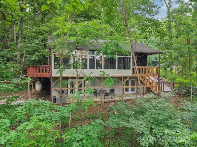 58 Oak Ter, Arden, NC 28704 - back of house featuring a sunroom, a wooden deck, a shingled roof, a patio area, and stairway