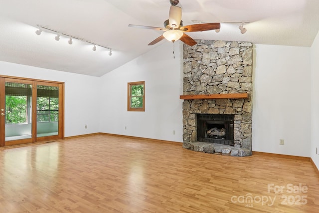 58 Oak Ter, Arden, NC 28704 - unfurnished living room featuring track lighting, wood finished floors, vaulted ceiling, ceiling fan, and a fireplace