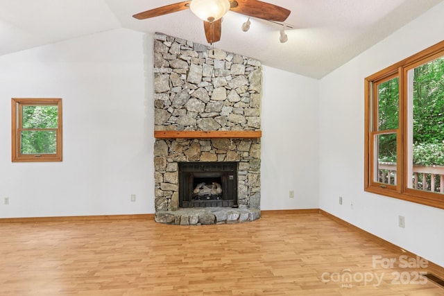 58 Oak Ter, Arden, NC 28704 - unfurnished living room with lofted ceiling, wood finished floors, a ceiling fan, and a fireplace